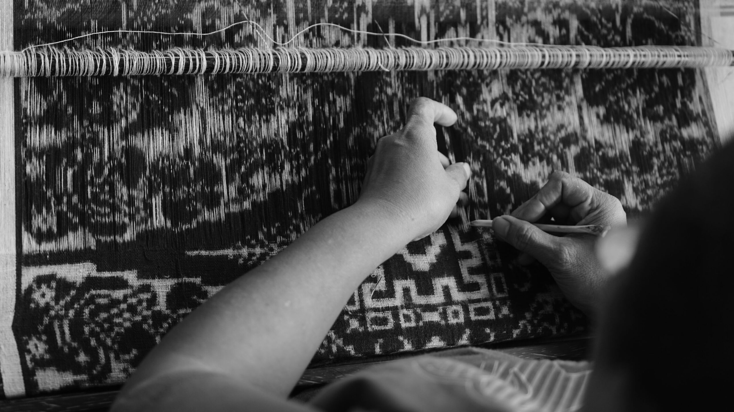 gray scale photo of woman holding needle